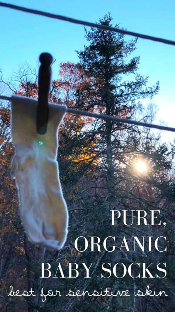 The text "pure, organic baby socks best for sensitive skin" is on an image showing a baby sock on a clothesline on a sunny autumn day.